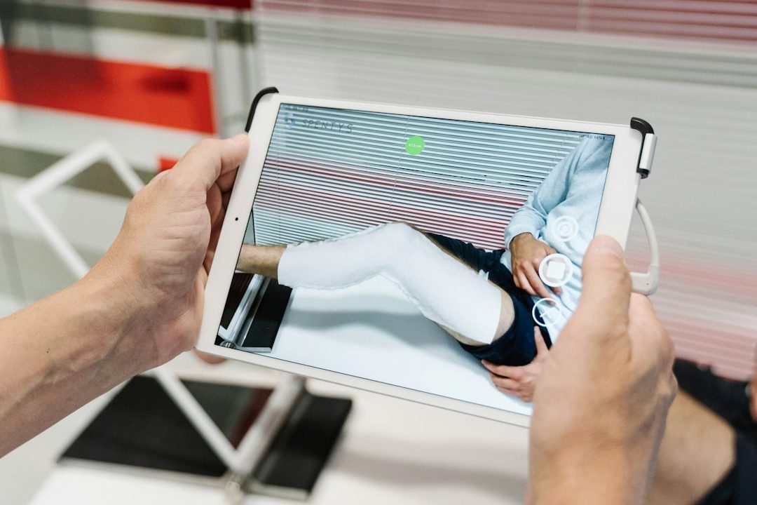 person holding white tablet computer